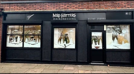 Front view of Arlenzo_hair salon in Stafford, England, GB with elegant seasonal window displays.
