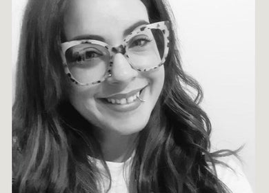 Smiling woman with stylish glasses at Arlenzo_hair, Stafford, England, GB.