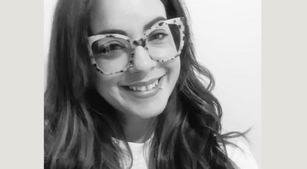 Smiling woman with stylish glasses at Arlenzo_hair, Stafford, England, GB.