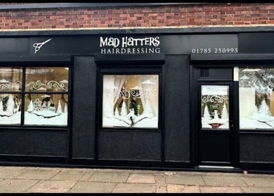Exterior of Arlenzo_hair in Stafford, England, GB, decorated with winter scenes on windows.