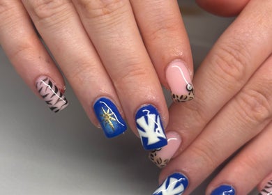 Beautiful nail art at Beautè By Millie, Douglas, GB showcasing bold blue and animal print designs.