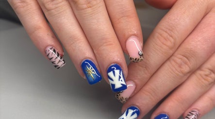 Beautiful nail art at Beautè By Millie, Douglas, GB showcasing bold blue and animal print designs.