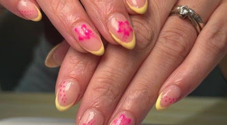 Floral pink and yellow nail art at Beautè By Millie, Douglas, GB.