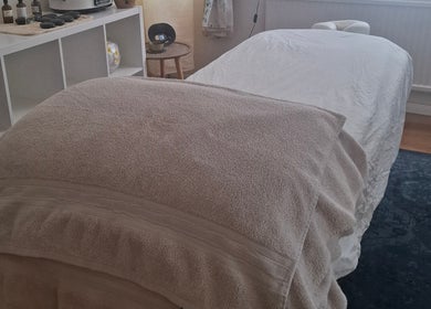 Cozy massage table at Just Natural Therapies, Poole, England, GB, ready for a relaxing session.