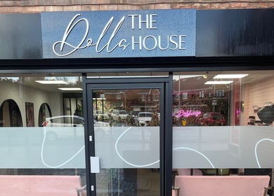 Entrance of The Dollshouse Hair By Nat in Shortheath, England with modern black and white decor.