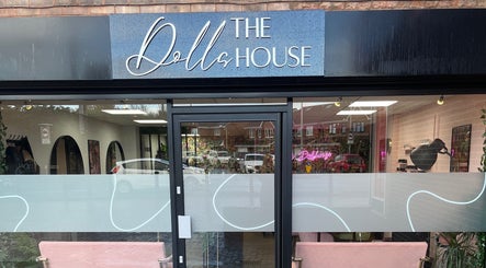 Entrance of The Dollshouse Hair By Nat in Shortheath, England with modern black and white decor.