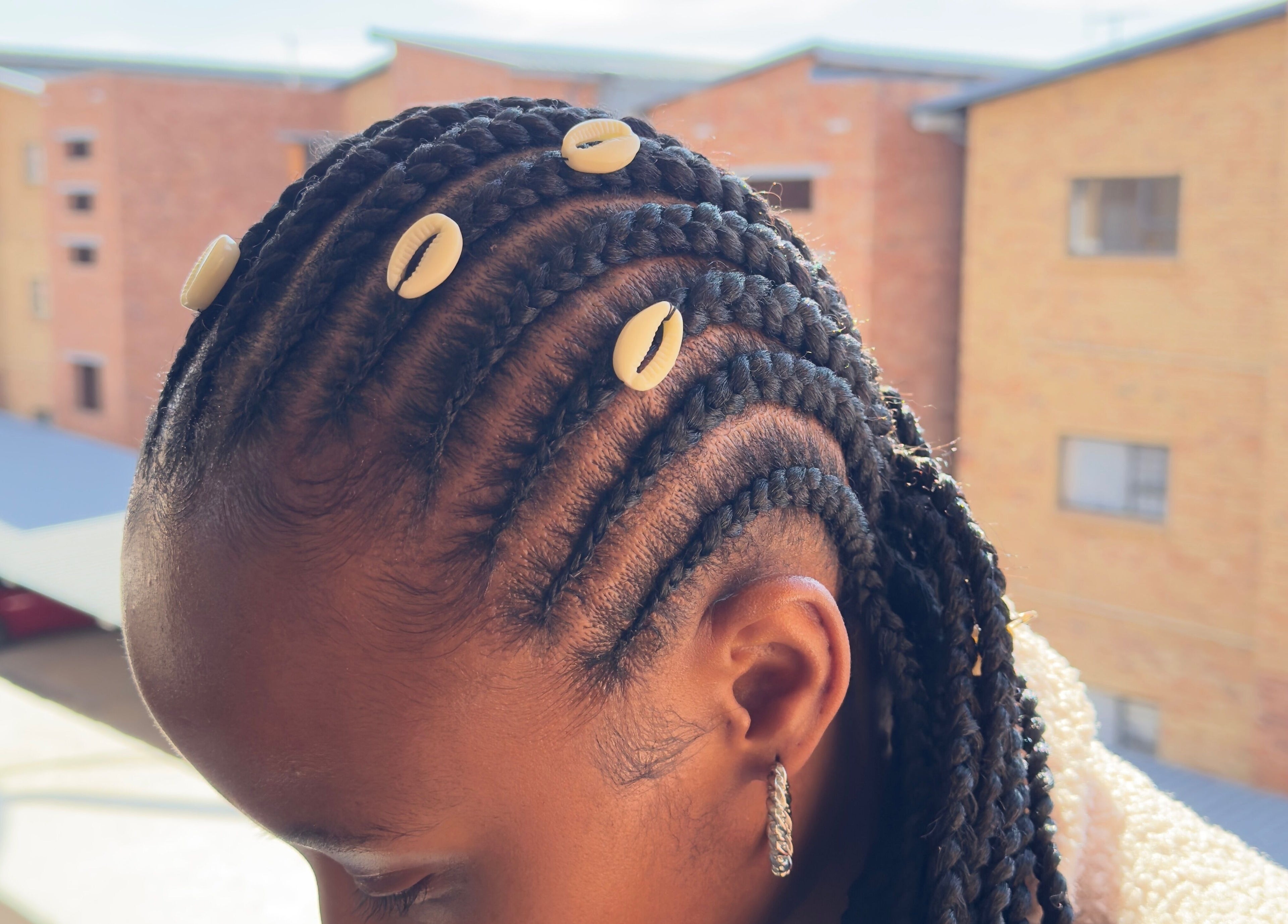 Elegant braided hairstyle with beads at Randburg hair salon, Randburg, Gauteng, ZA.