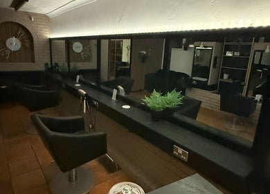 Modern salon interior at HairbyMichelle_210 in Lowestoft, England, GB with sleek styling chairs and mirrors.