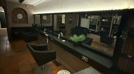 Modern salon interior at HairbyMichelle_210 in Lowestoft, England, GB with sleek styling chairs and mirrors.