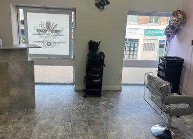 Contemporary salon interior at Lisas Hair Loft, Dumbarton, Scotland, GB, featuring sleek styling stations.