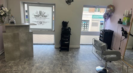 Contemporary salon interior at Lisas Hair Loft, Dumbarton, Scotland, GB, featuring sleek styling stations.