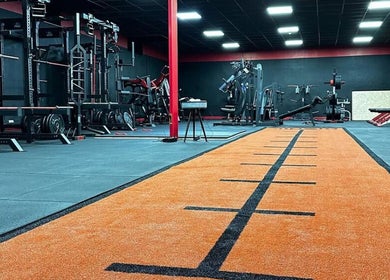 Spacious gym interior at Allison Grace Sports Massage, Oldham, England, GB, featuring advanced fitness equipment.