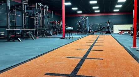 Spacious gym interior at Allison Grace Sports Massage, Oldham, England, GB, featuring advanced fitness equipment.
