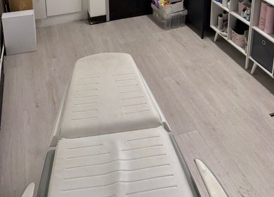 Therapy room at Allison Grace Sports Massage Therapist in Skelmersdale, England, GB. White table, organized shelves.