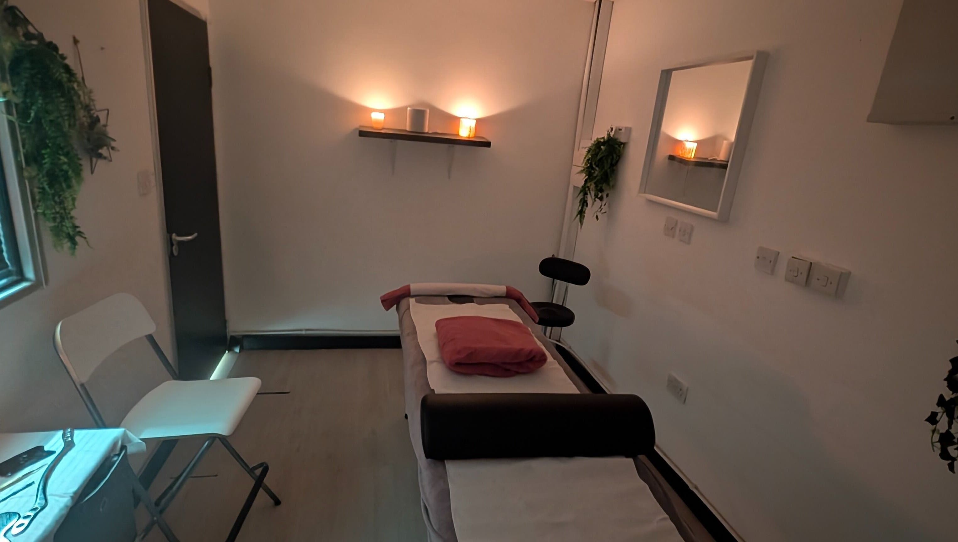 Relaxing massage room at Allison Grace Sports Massage Therapist in Skelmersdale, England, GB, with candles and plants.