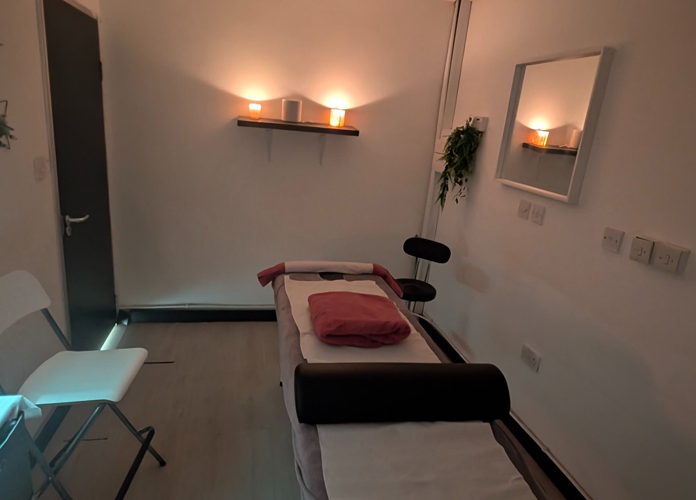 Relaxing massage room at Allison Grace Sports Massage Therapist in Skelmersdale, England, GB, with candles and plants.