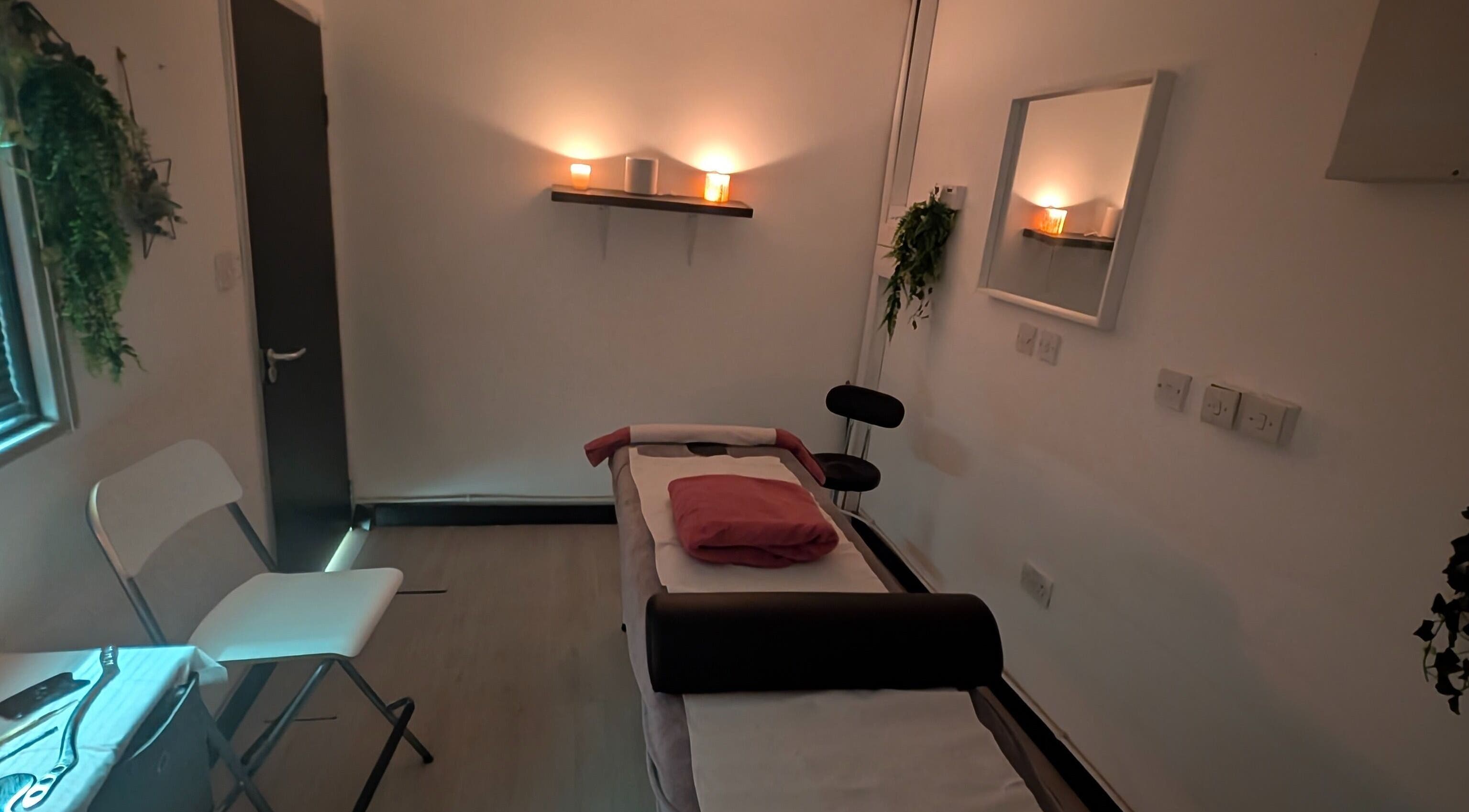 Relaxing massage room at Allison Grace Sports Massage Therapist in Skelmersdale, England, GB, with candles and plants.