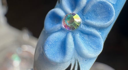 Uña con diseño floral azul y piedra brillante en Bymarietperez, Orlando, Florida, US.