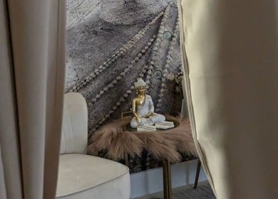 Cozy nook with Buddha statue at Tranquil Touch Spa in Atlanta, Georgia, US for ultimate relaxation.