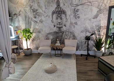 Relaxing seating area with Buddha mural at Tranquil Touch Spa, Atlanta, Georgia, US.
