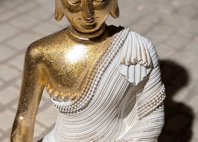 Elegant golden Buddha statue at Tranquil Touch Spa, Atlanta, Georgia, US, enhancing serene ambiance.