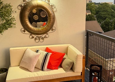Relaxing balcony lounge at Tranquil Touch Spa in Atlanta, Georgia, US, featuring cozy seating and greenery.
