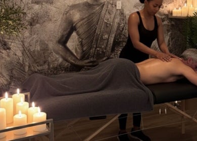 Massage therapy session at Tranquil Touch Spa in Atlanta, Georgia, US with serene candlelit ambiance.