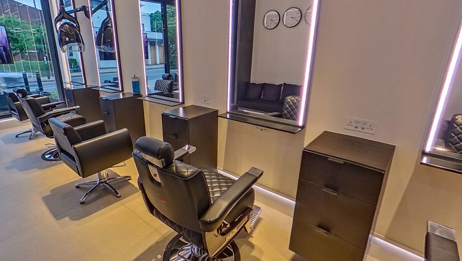 Modern interior of MarkconHDCUTZ salon in London, England, GB featuring sleek styling chairs and mirrors.