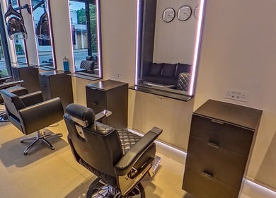 Modern interior of MarkconHDCUTZ salon in London, England, GB featuring sleek styling chairs and mirrors.