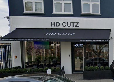 Exterior view of MarkconHDCUTZ salon in London, England, GB, showcasing modern design and signage.
