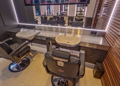 Modern barber chairs and sinks at MarkconHDCUTZ in London, England, GB showcasing sleek design.