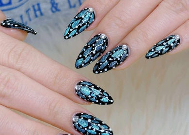 Elegant black and blue nail art at Ivy Rose Nails Ormeau, Ormeau, Queensland, AU, showcasing intricate patterns.