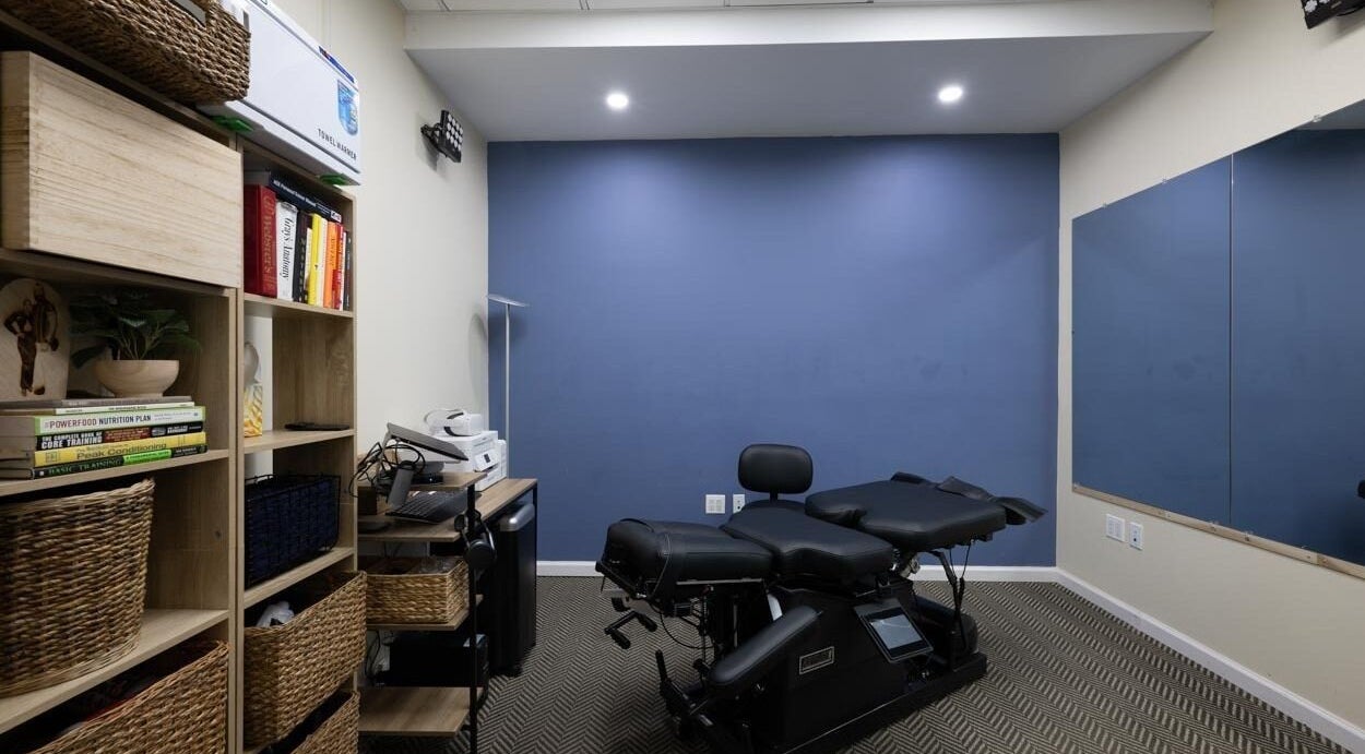 Chic therapy room at Fixinhumans, New York, New York, US, featuring modern equipment and a calming blue wall.