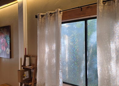 Elegant drapes and floral art at Dharma River ZenFloat Spa, Daphne, Alabama, US create a serene atmosphere.