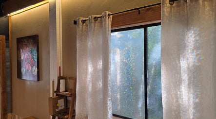 Elegant drapes and floral art at Dharma River ZenFloat Spa, Daphne, Alabama, US create a serene atmosphere.