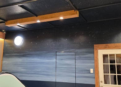 A serene room at Dharma River ZenFloat Spa in Daphne, Alabama, US, featuring starry night ceiling lighting.