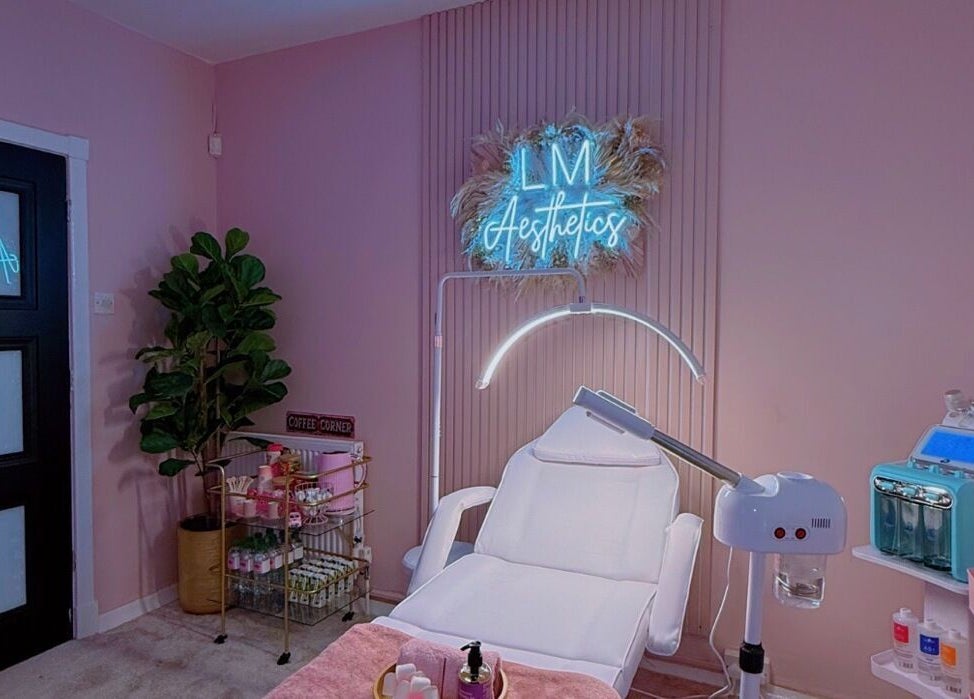 Elegant treatment room at LM Aesthetics in Oldham, England, GB with cozy decor and professional equipment.