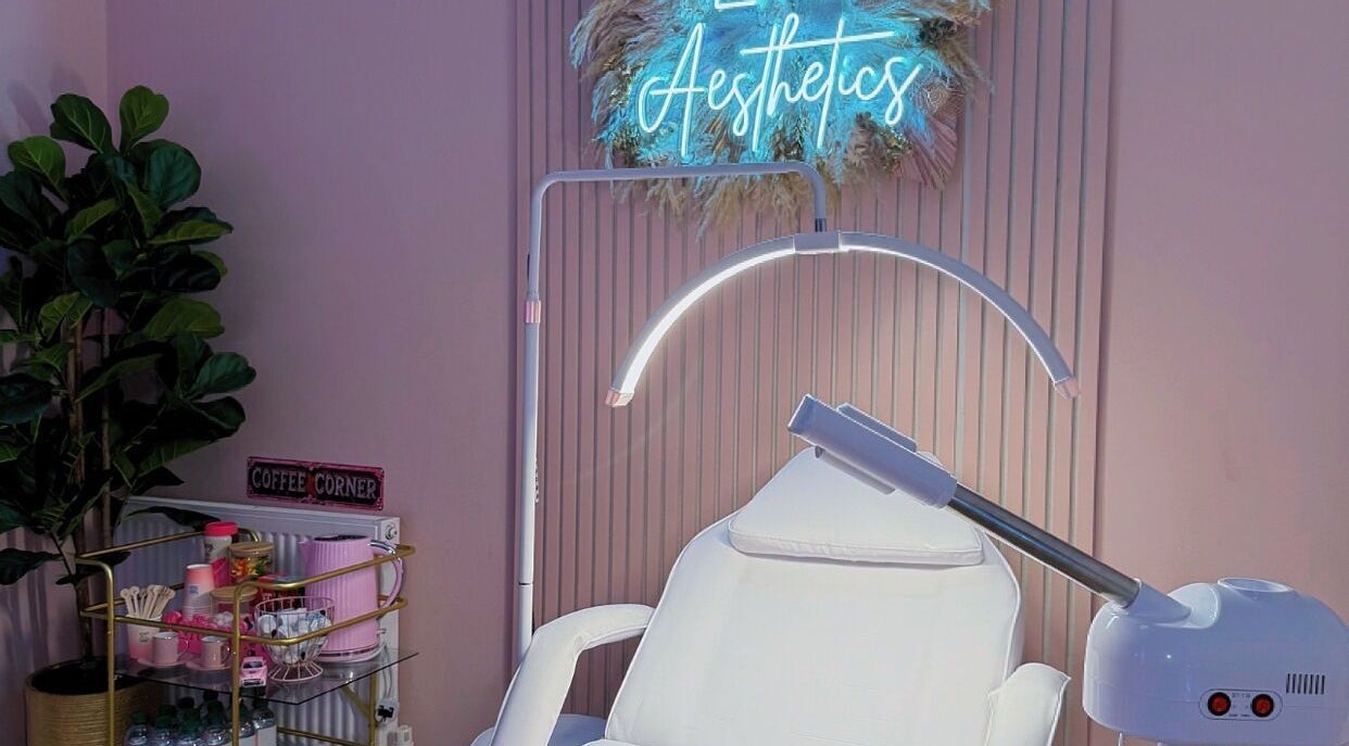 Relaxing treatment room at LM Aesthetics, Oldham, England, GB with soothing lighting and plush seating.