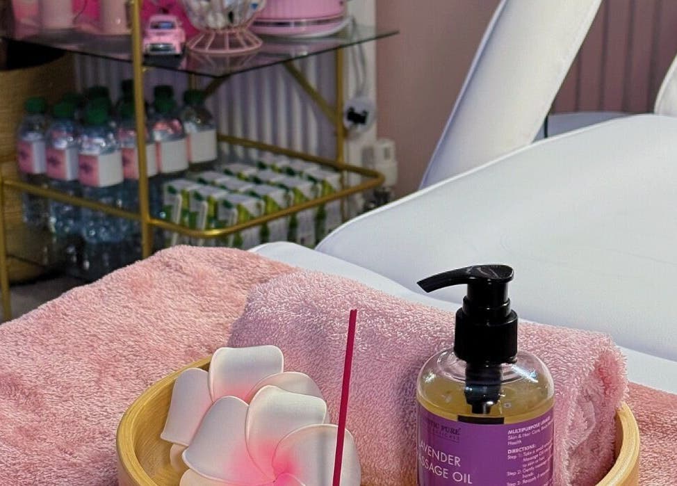 Lavender massage oil and towels at LM Aesthetics in Oldham, England, GB create a serene spa atmosphere.