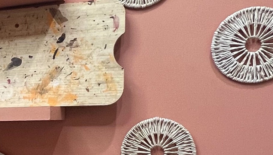 Artistic decor with circular patterns on a peach wall at The Vibe Cove, Tempe, Arizona, US.