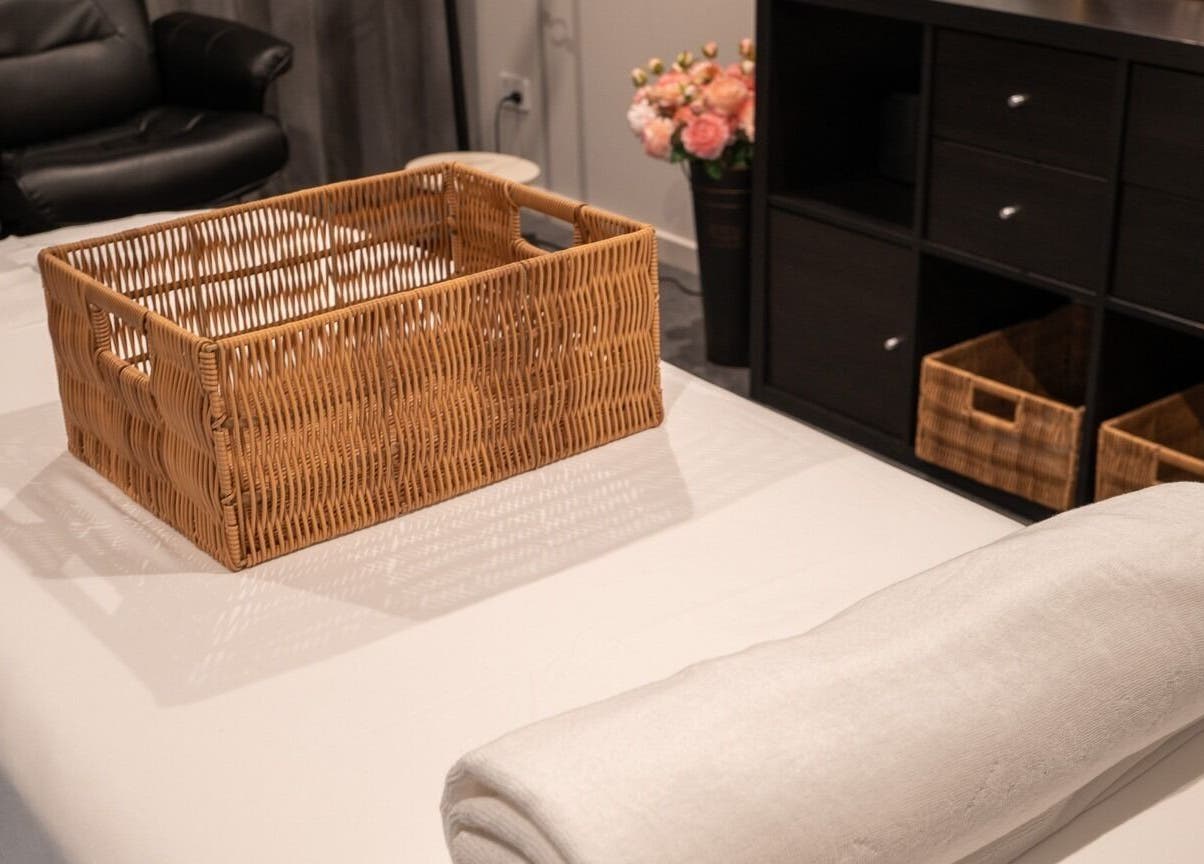 Relaxing room at Youre Soul, Thornlands, Queensland, AU, featuring a wicker basket and plush massage bed.