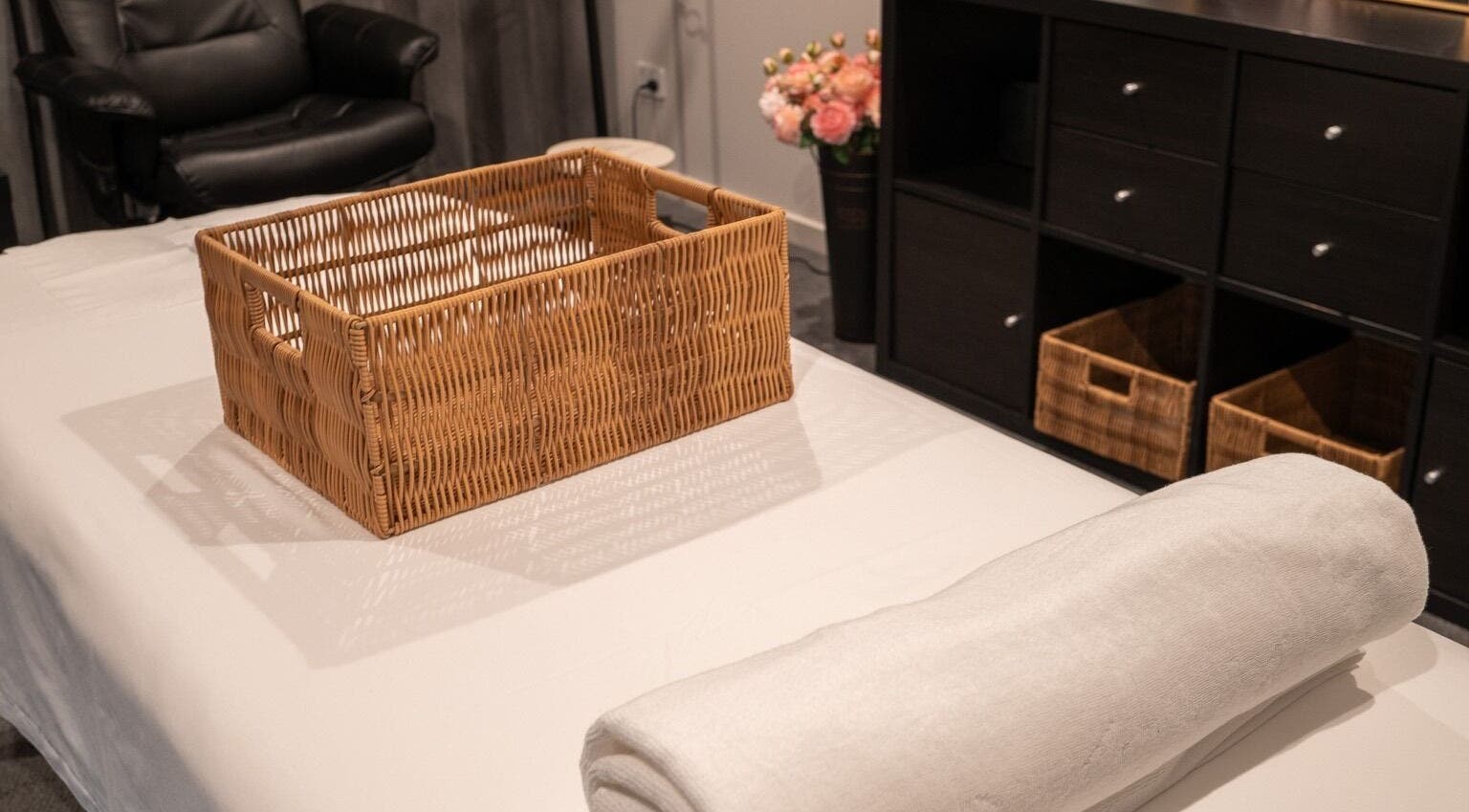 Relaxing room at Youre Soul, Thornlands, Queensland, AU, featuring a wicker basket and plush massage bed.