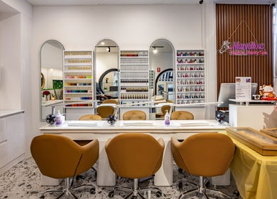 Elegant interior of Marvellous Nail & Beauty Spa, Melbourne, Victoria, AU showcasing nail stations and vibrant decor.