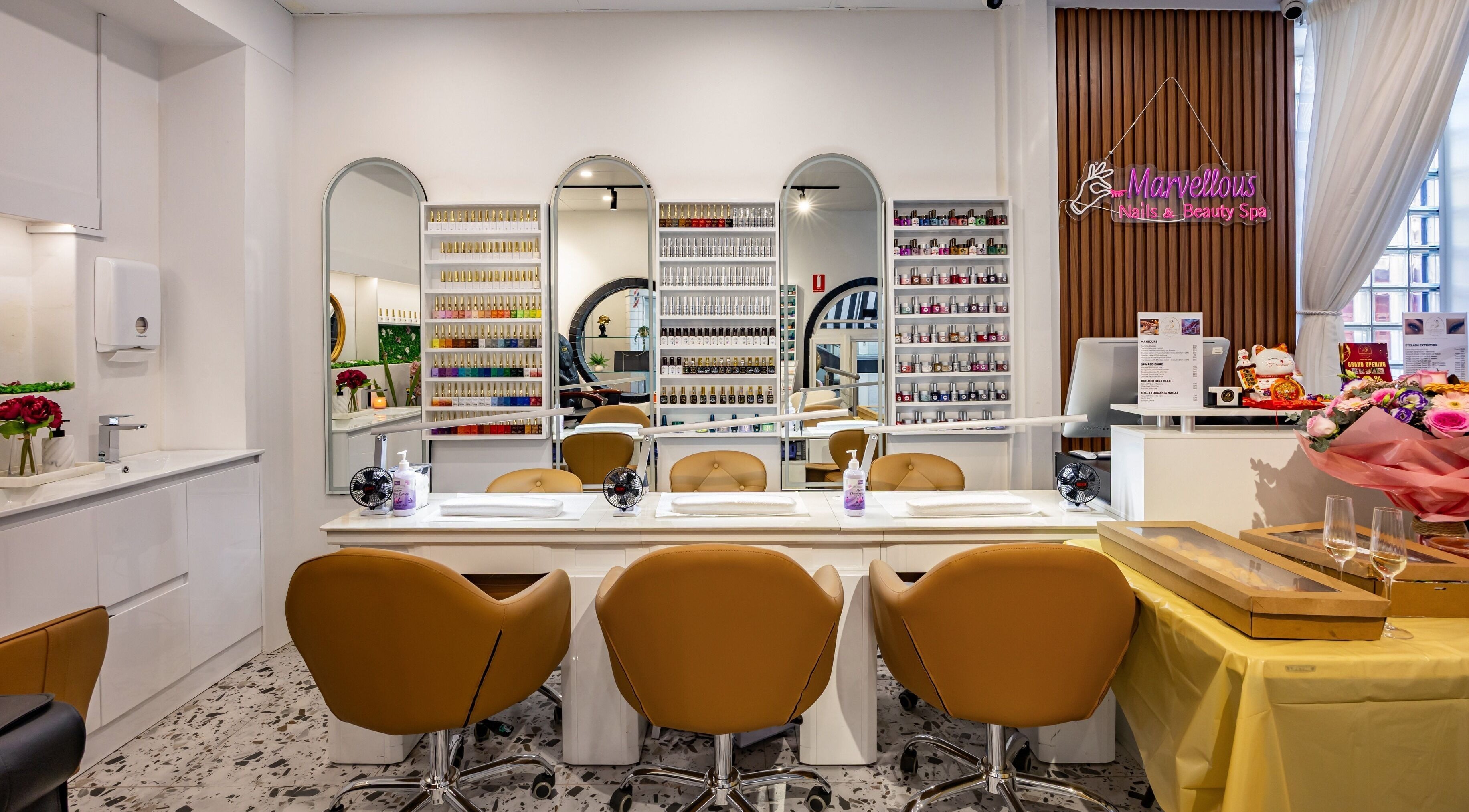 Elegant interior of Marvellous Nail & Beauty Spa, Melbourne, Victoria, AU showcasing nail stations and vibrant decor.