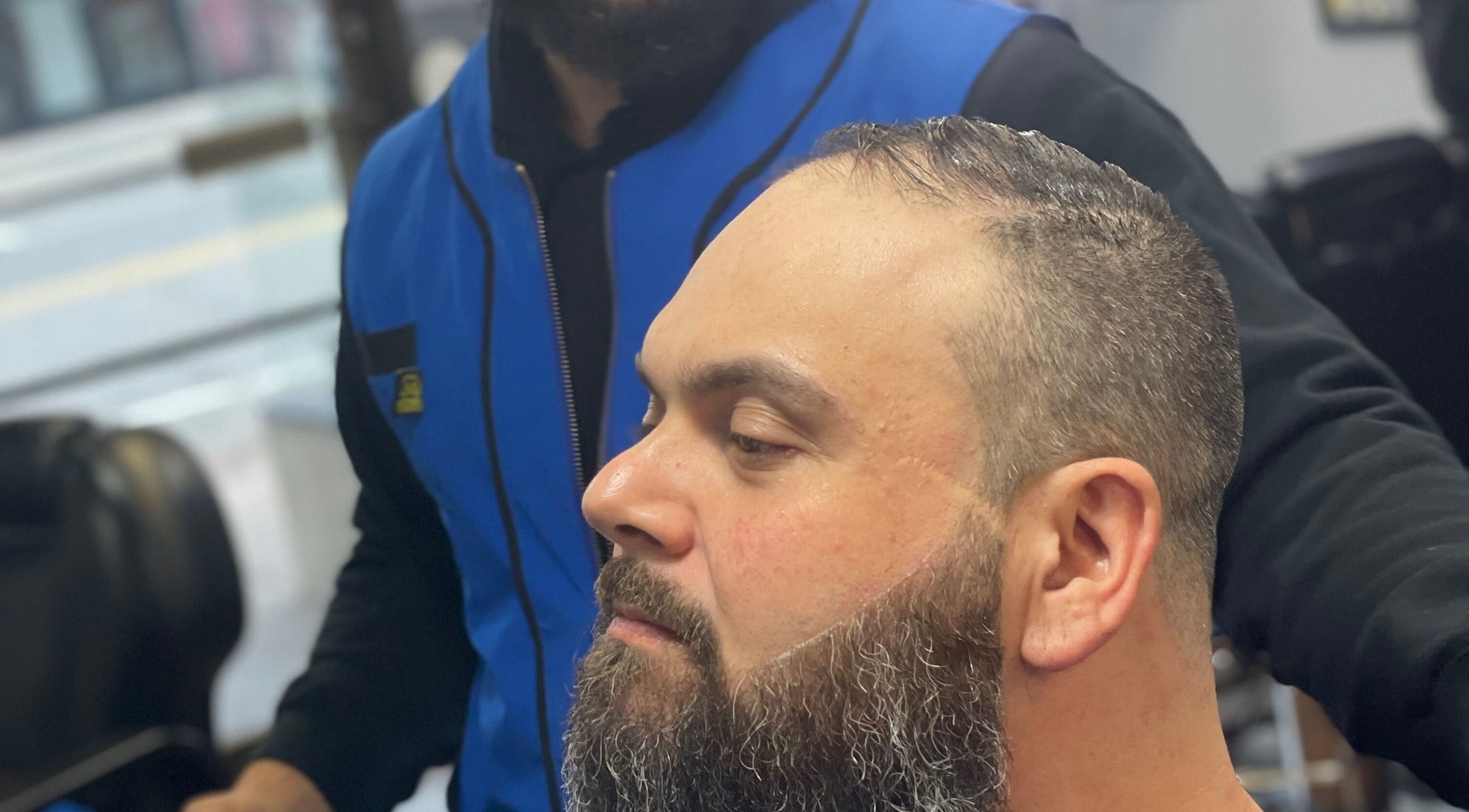 Client receiving precise beard trim at Luisthebarber-evolutionpatchogue, Patchogue, New York, US.