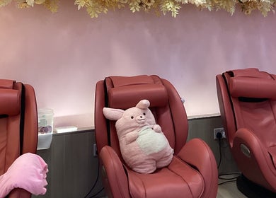 Comfortable pink massage chairs at Nail Market Studio, Singapore, Singapore, SG with plush décor.