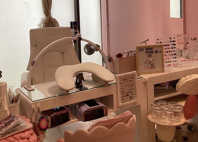 Elegant nail station at Nail Market Studio, Singapore, SG with comfy chairs and nail tools.