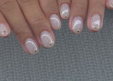 Elegant white glitter nails with gold accents at Nail Market Studio, Singapore, SG.