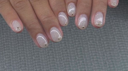 Elegant white glitter nails with gold accents at Nail Market Studio, Singapore, SG.