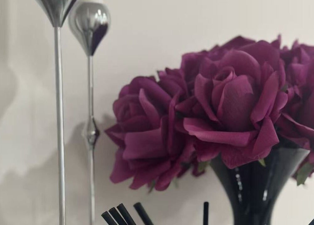 Elegant purple roses in a black vase at Ppsu Nails & Lashes Studio, Winnipeg, Manitoba, CA.